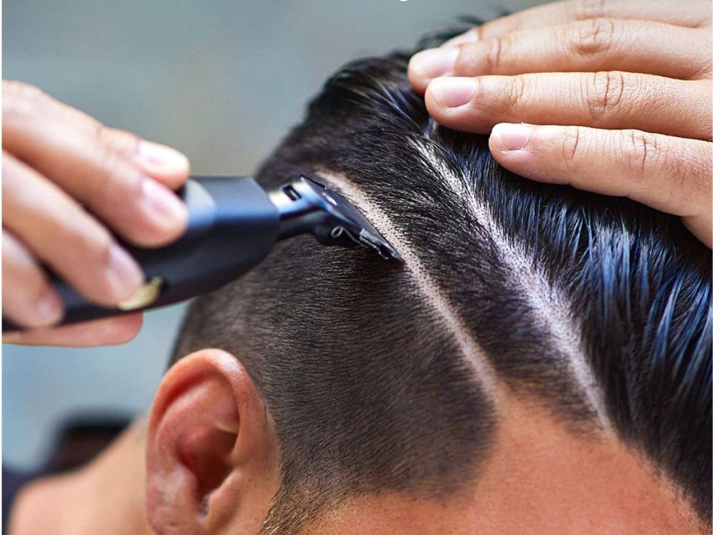 man using trimmer on hair