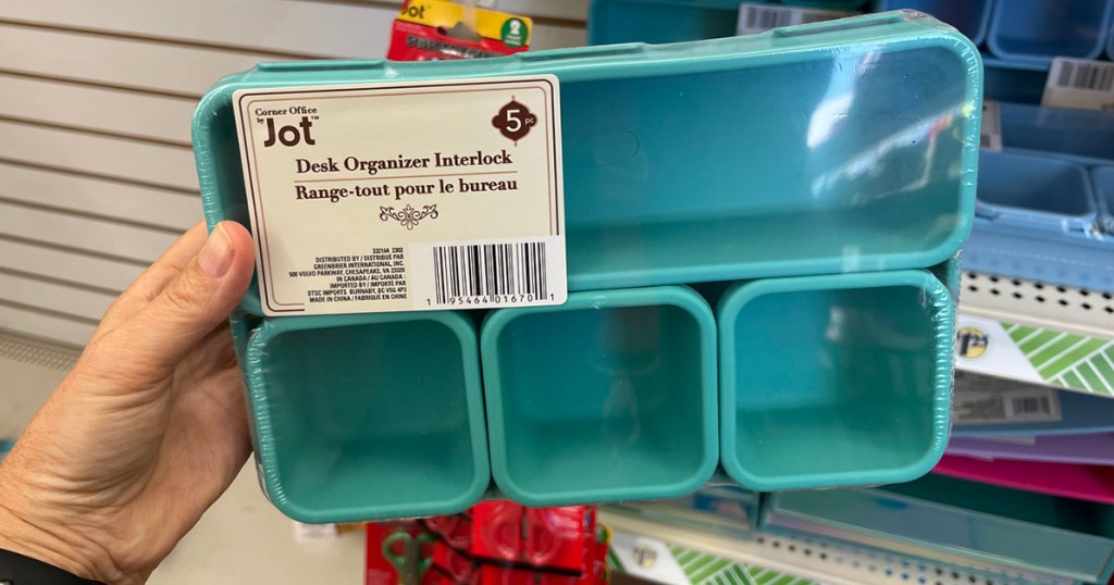 hand holding jot desk organizer in teal