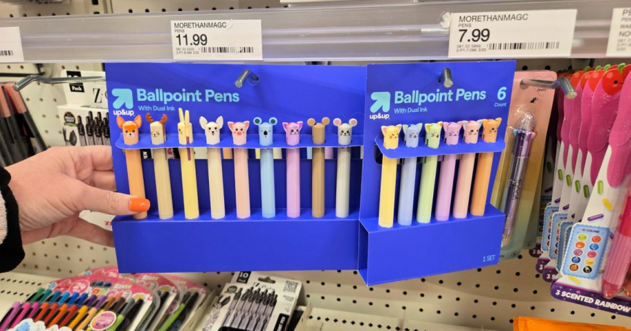 woman holding a pack of novelty pens in store