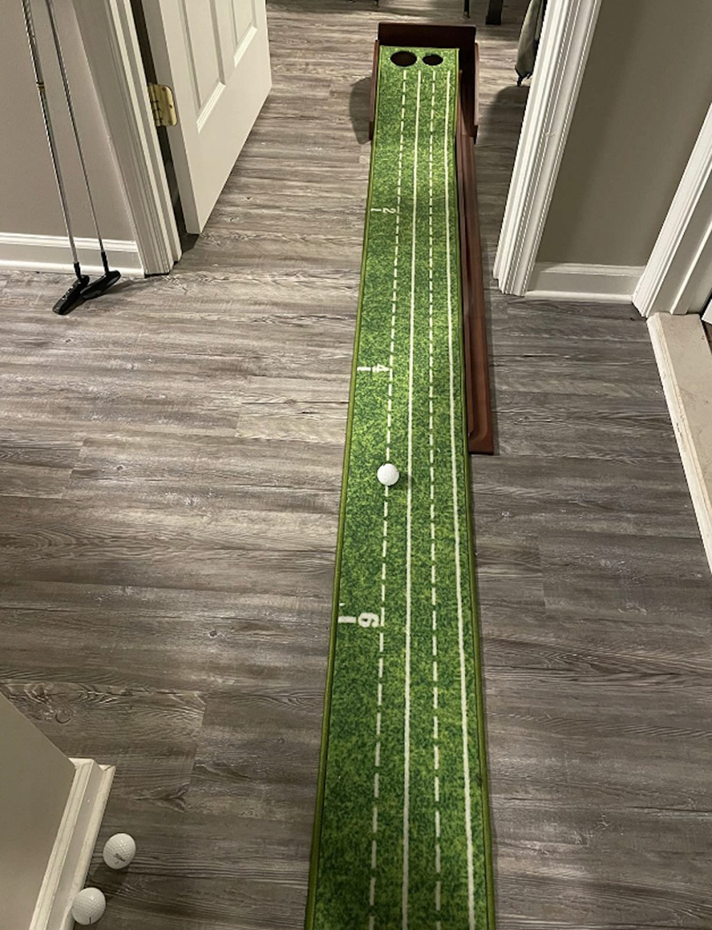 putting green sitting on gray wood floor
