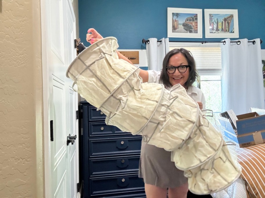 woman holding a mainstays hanging closet organizer
