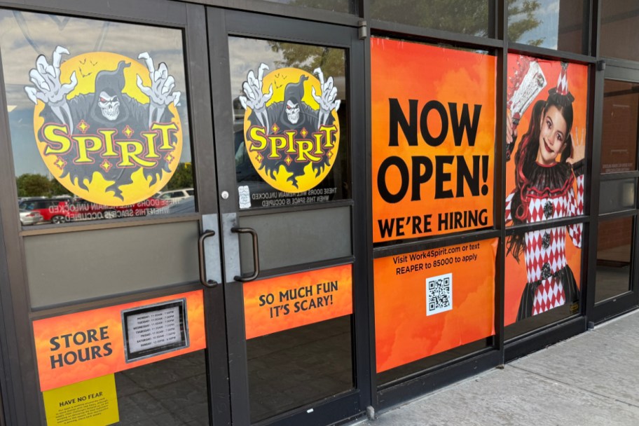 front doors of halloween store showing now open