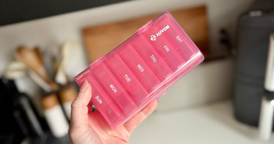 hand holding AUVON Pill Organizer