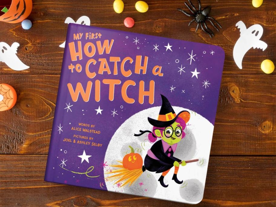 My First How to catch a witch board book on a table with halloween decor items