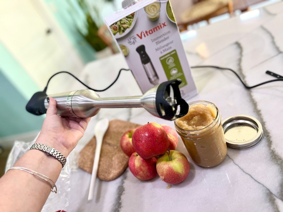 holding immersion blender up after making applesauce
