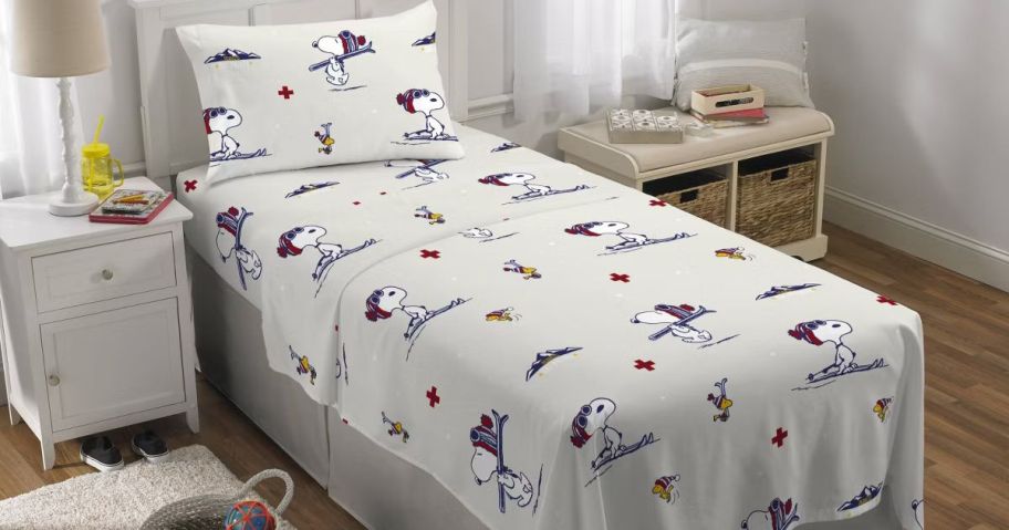 A bed with Peanuts Sheets