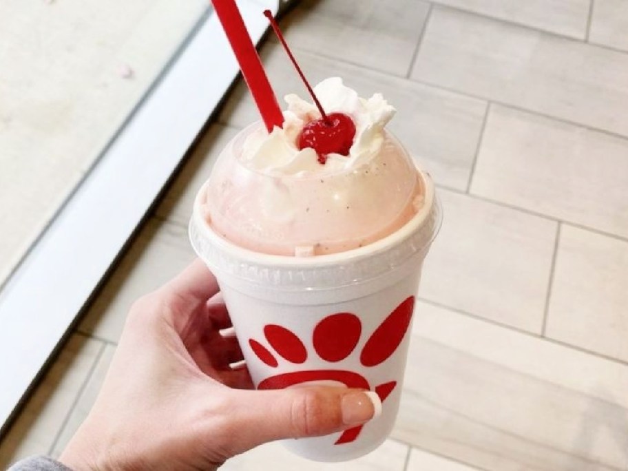 hand holding a Chick-fil-a peppermint milkshake
