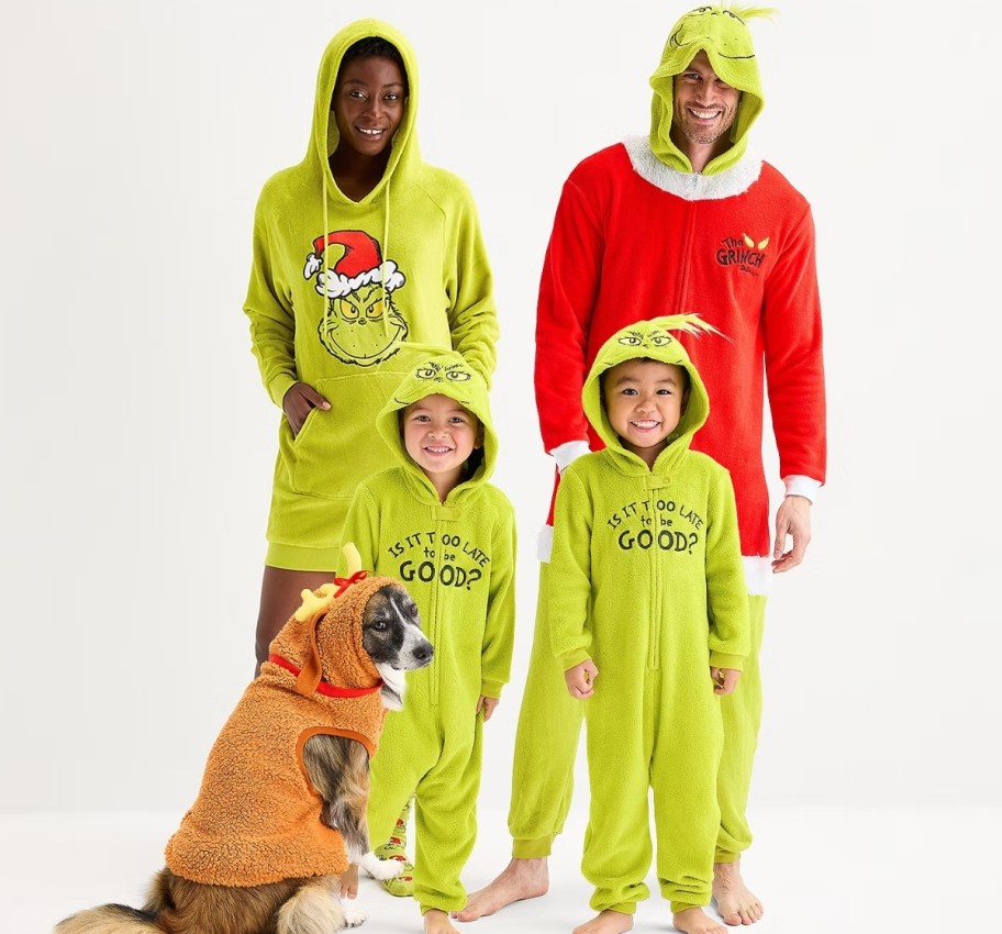 family of 4 wearing matching grinch family pjs