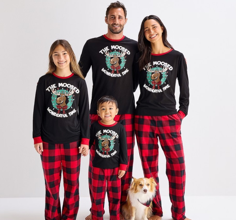 family of 4 wearing matching moose buffalo plaid family pjs