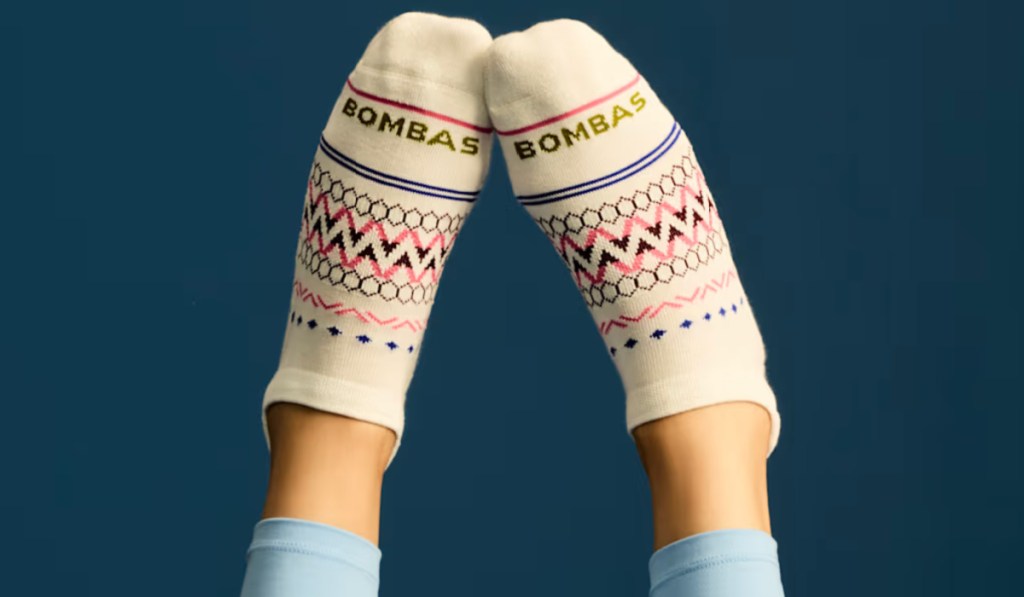 person wearing off-white bonus socks with a pattern and blue leggings