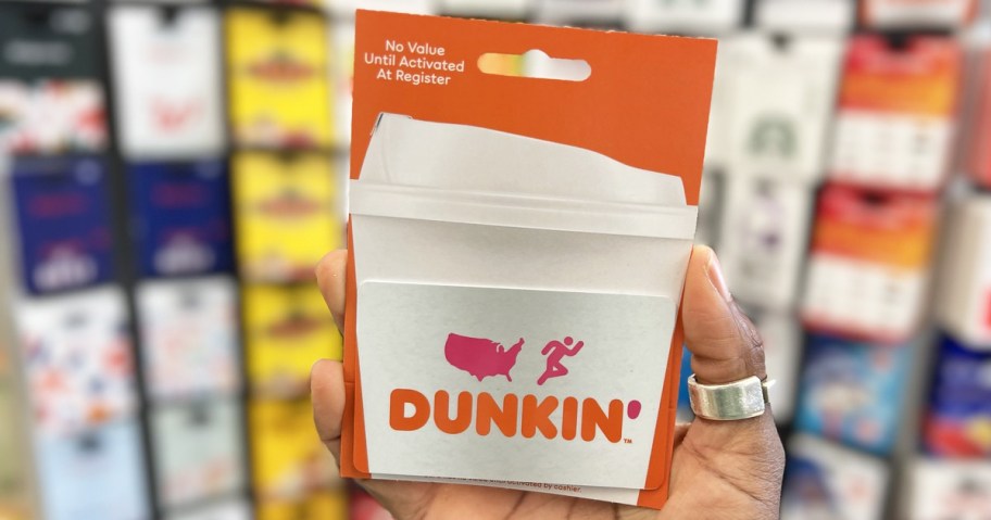 hand holding up an orange and white Dunkin' gift card