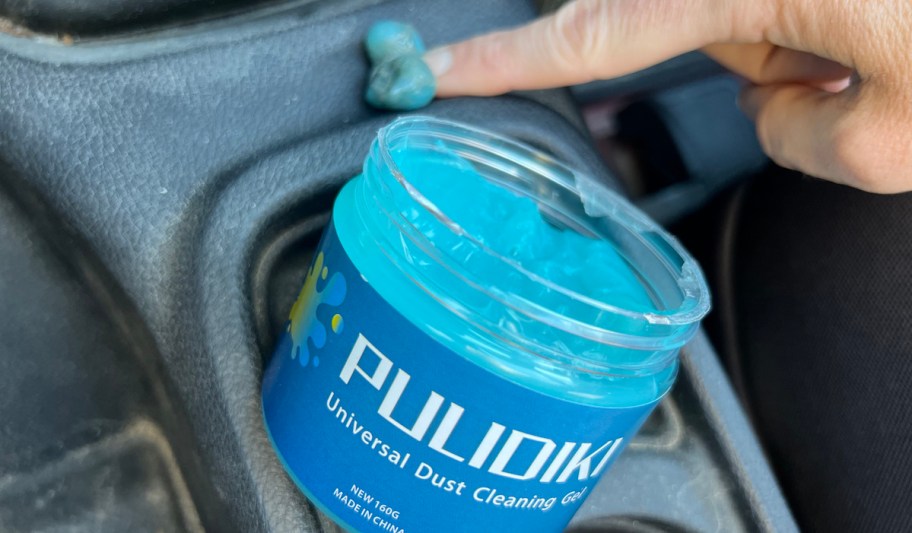 open container of blue cleaning gel in dirty car