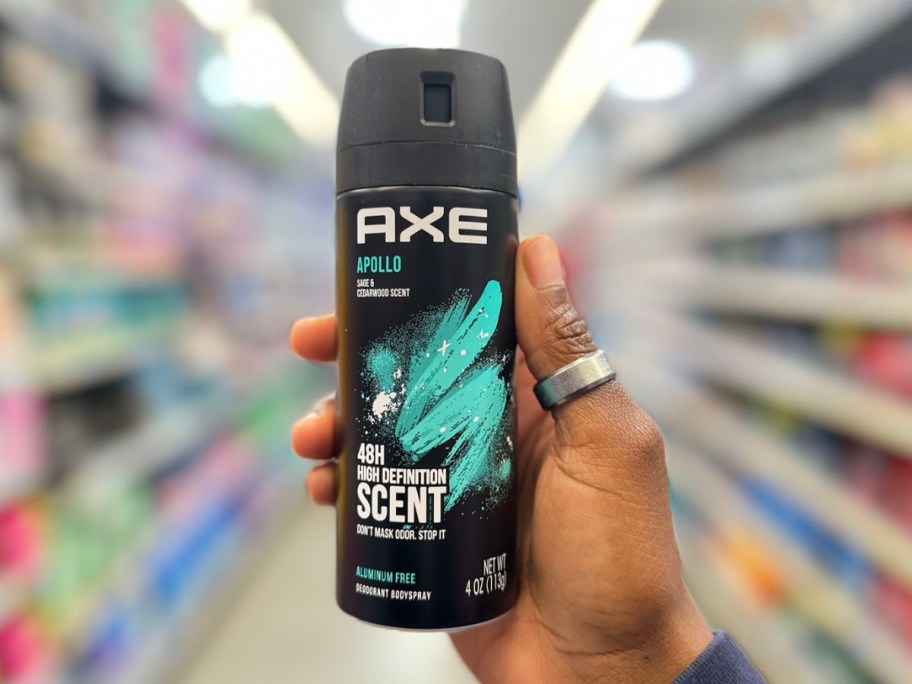 hand holding a can of axe body spray