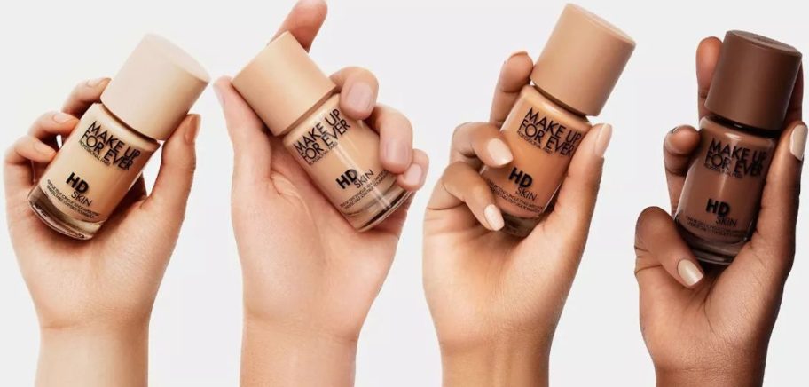 4 hands holding different shades of Make Up For Ever HD Skin Waterproof Natural Matte Foundation