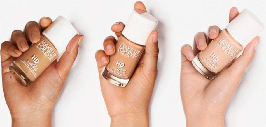 3 hands holding Make Up For Ever HD Skin Hydra Glow Foundation w/ Hyaluronic Acid