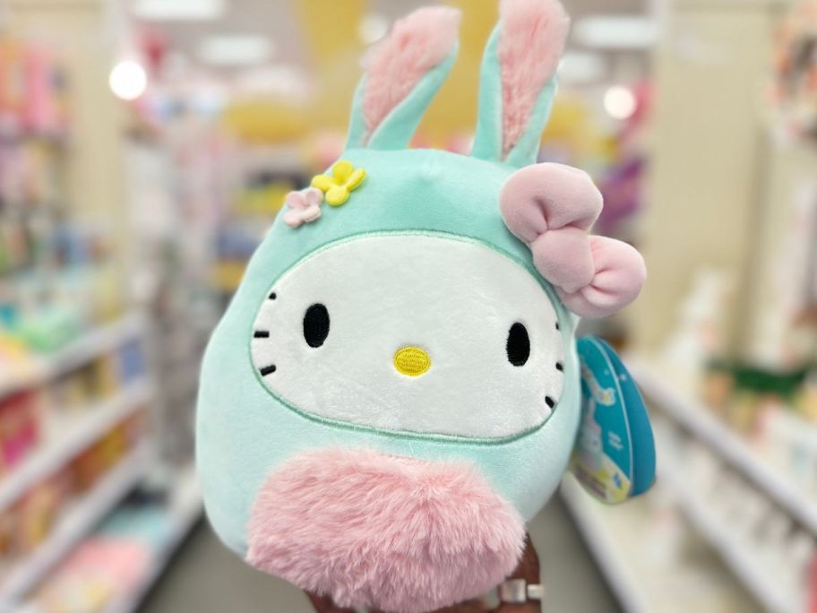 Hand holding up an Easter Bunny Hello Kitty Squishmallow
