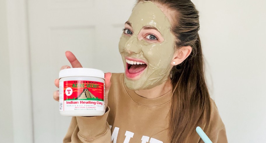woman holding up aztec healing clay with green face mask
