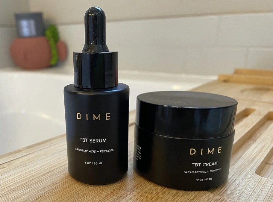 a bottle of TBT serum and jar of tbt cream from dime beauty