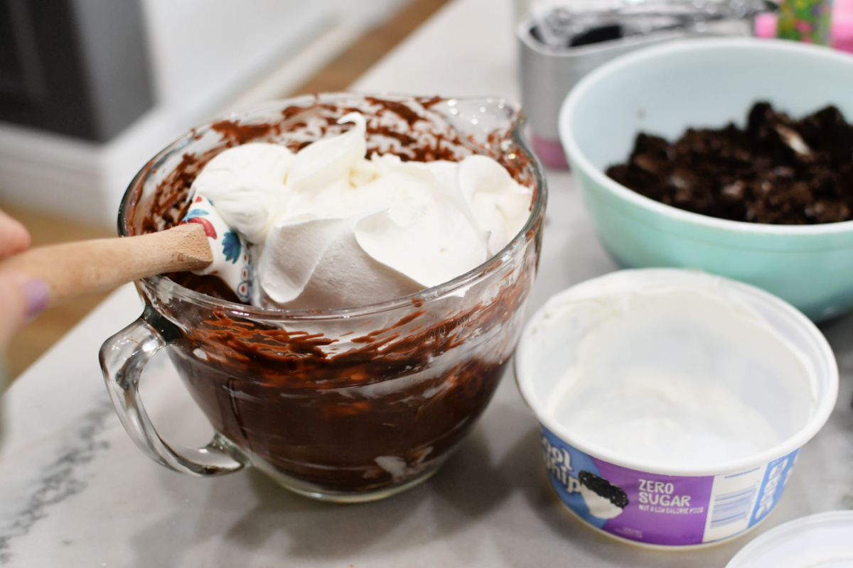 adding cool whip to pudding to create easter dirt cake