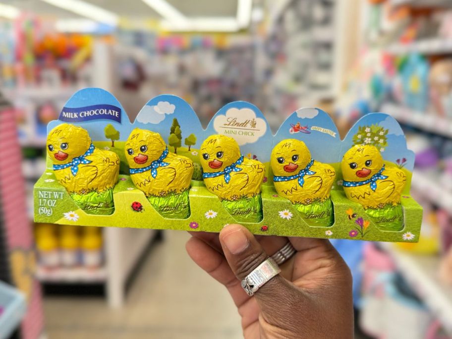 hand holding a 5 pack of Lindt&reg; Milk Chocolate Mini Chicks