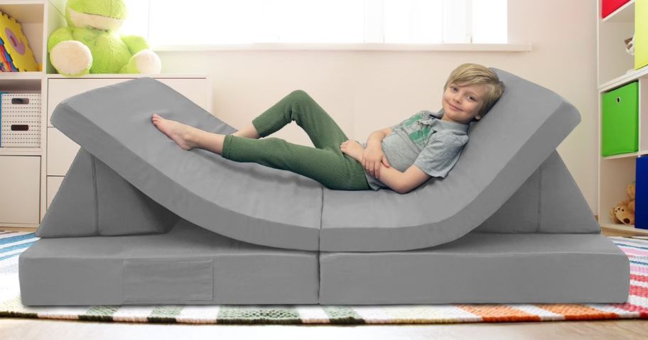 kid laying on imaginarium play couch