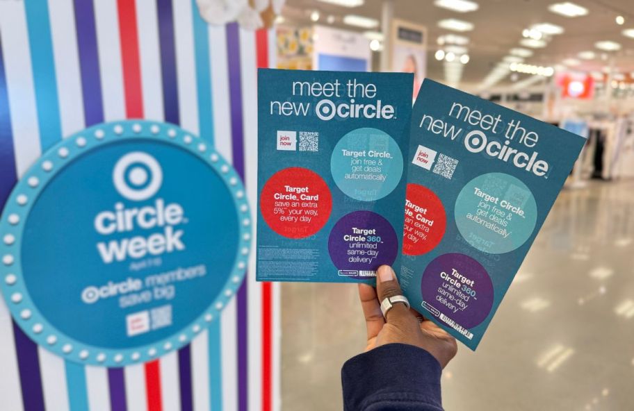 a womans hand holding target circle week ads