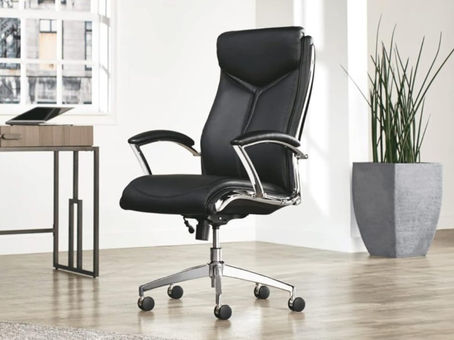 a black high back office chair in a home office