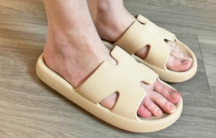 woman wearing a tan pair of cloud slides