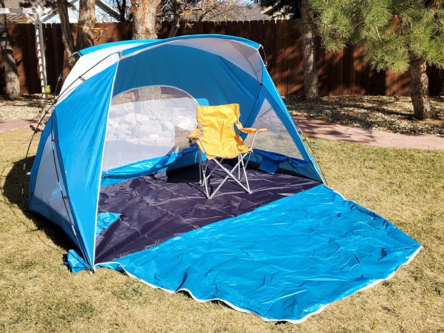 blue amazon tent with yellow summer chair inside of it.