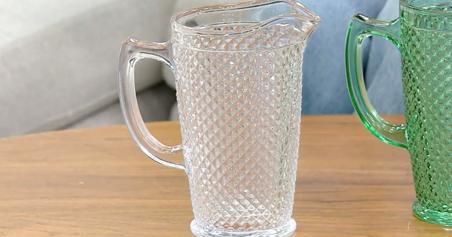 glass diamond cut pitcher sitting on table