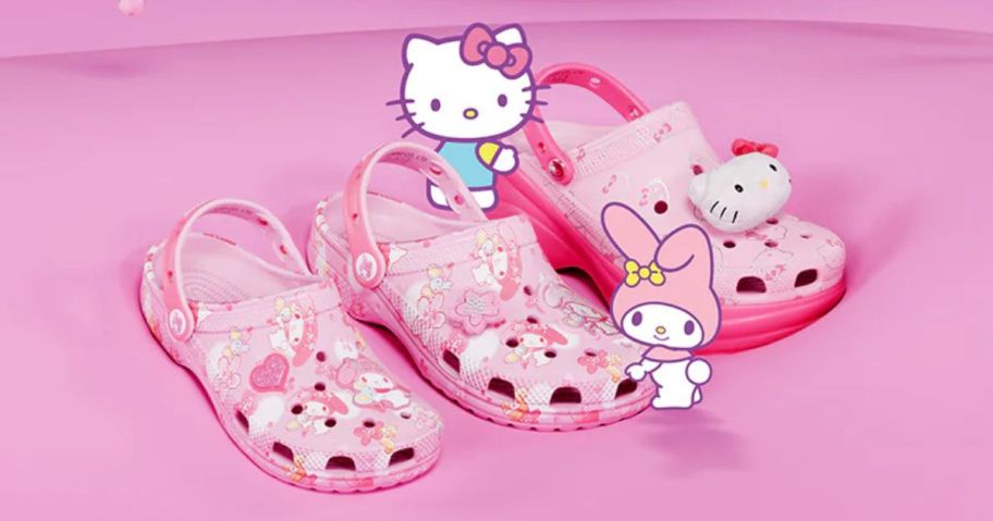 three pairs of sanrio hello kitty crocs with hello kitty characters standing next to them against a pink background