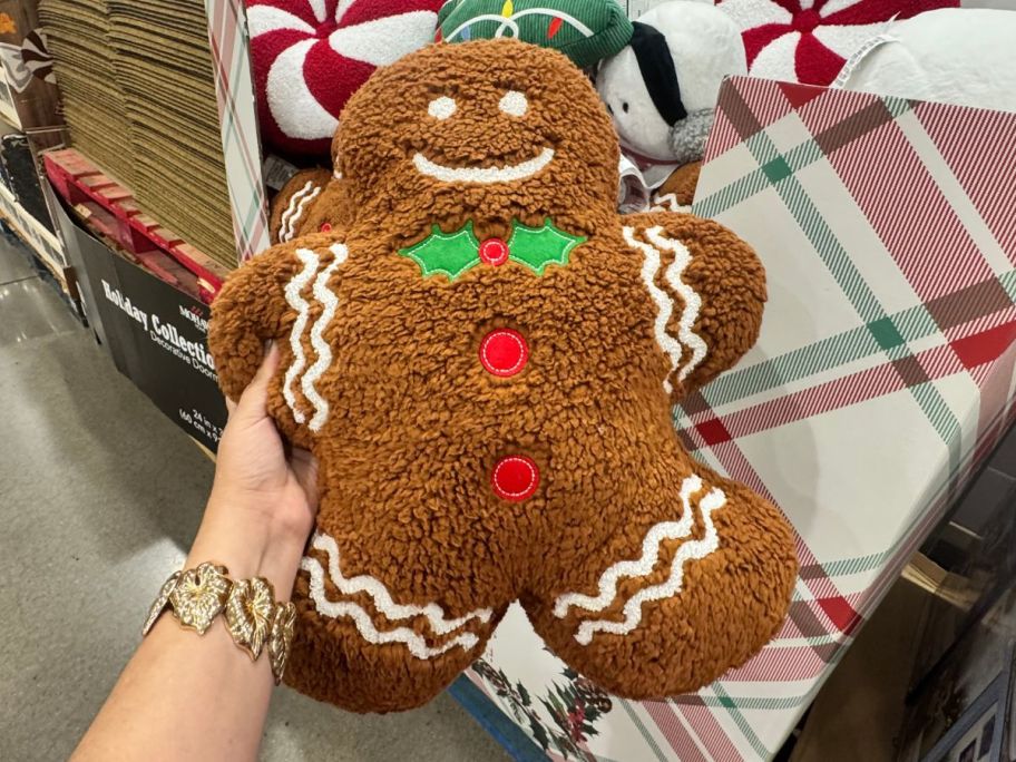 gingerbread man pillow in hand in store
