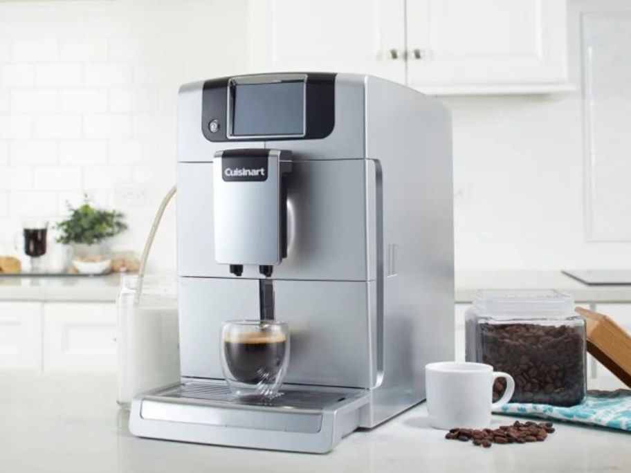 a silver espresso maker on a kitchen counter