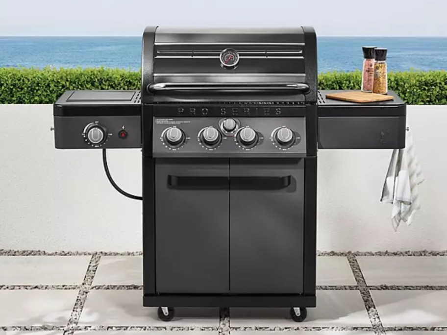 a black propane grill on a back patio