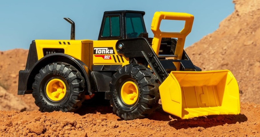 a Tonka Steel Classics Front Loader truck in the dirt