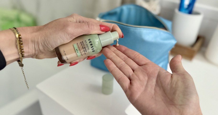 hand squirting Versed Multi-Serum Skin Tint Foundation on fingers