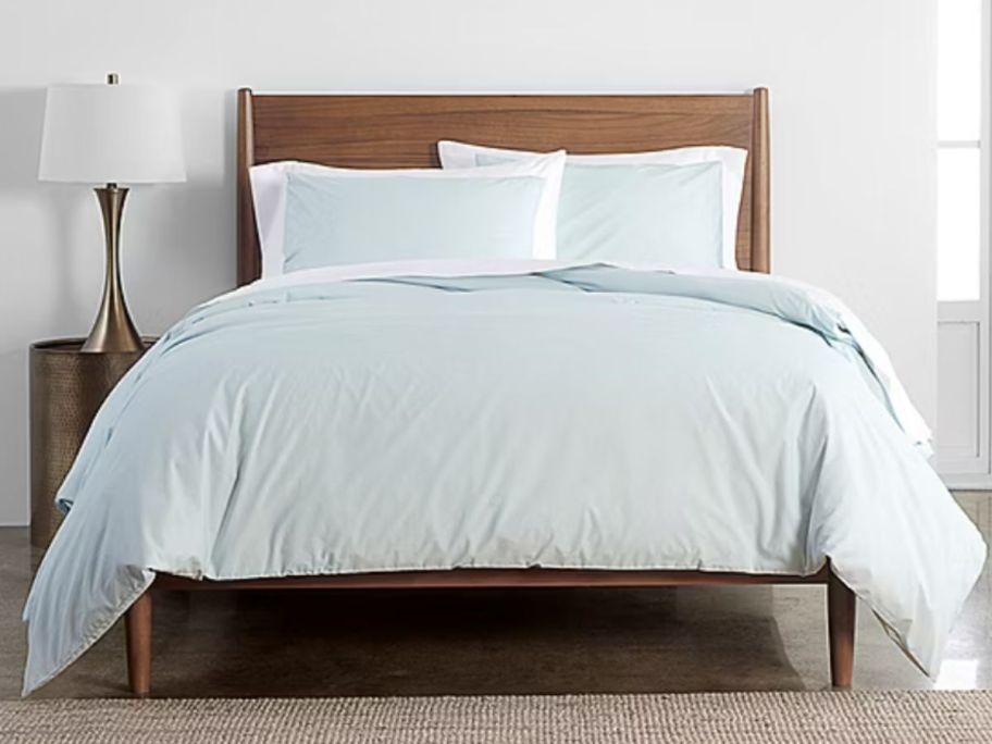 light green duvet on bed in bedroom