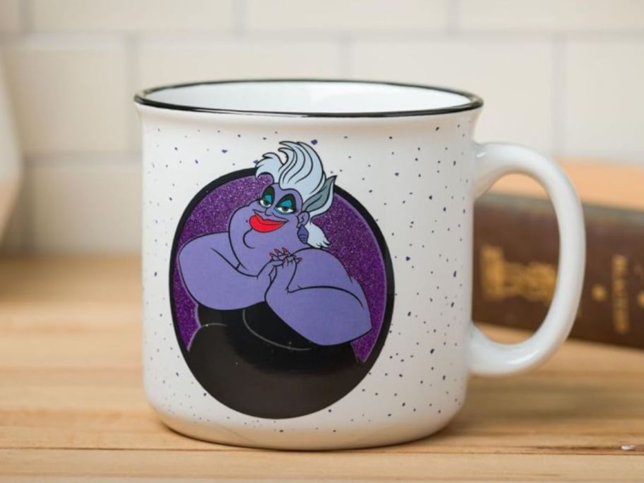 Silver Buffalo Disney Ursula Poor Unfortunate Souls Glitter Ceramic Camper Mug 20oz on counter