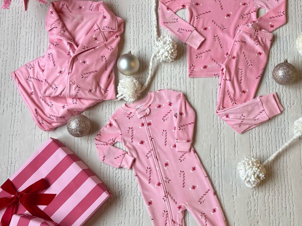 Carter's pink peppermint pajamas on beige carpet
