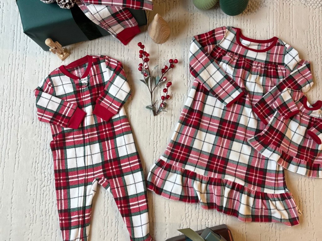 Carter's baby plaid pajamas on beige carpet
