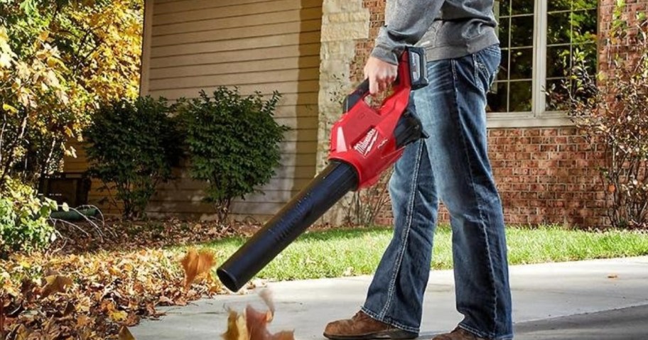 man using a leaf blower outside