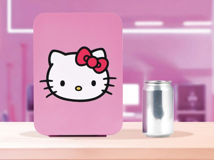 A small pink fridge with a Hello Kitty face upon it 