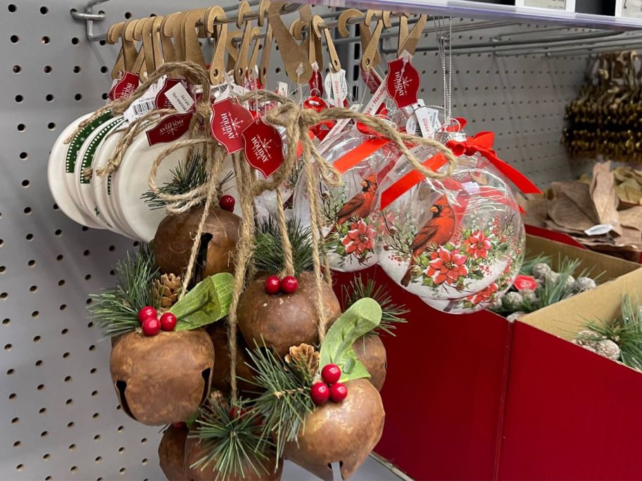 Holly Bell and Cardinal Snow Globe displayed in a store