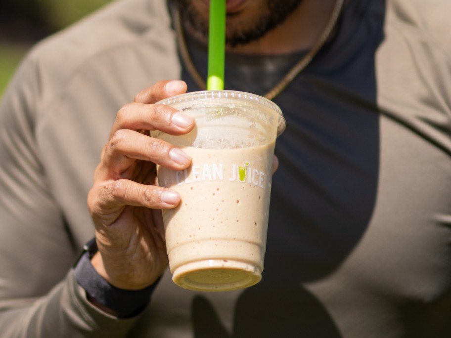 holding a frozen coffee drink
