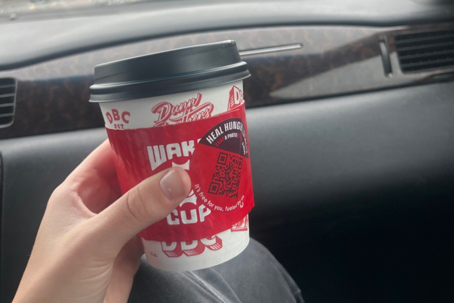 holding a coffee cup in a car