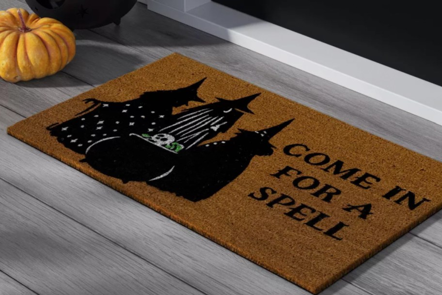 three witches on tan coir doormat