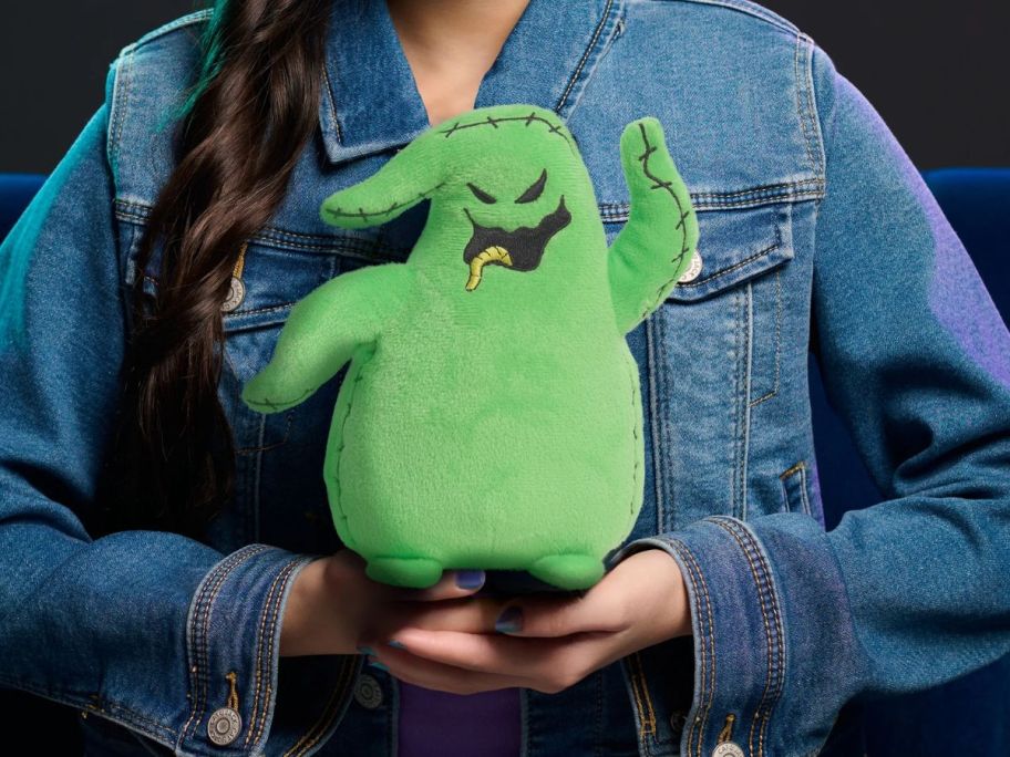 kid holding nightmare before christmas oogie boogie plush