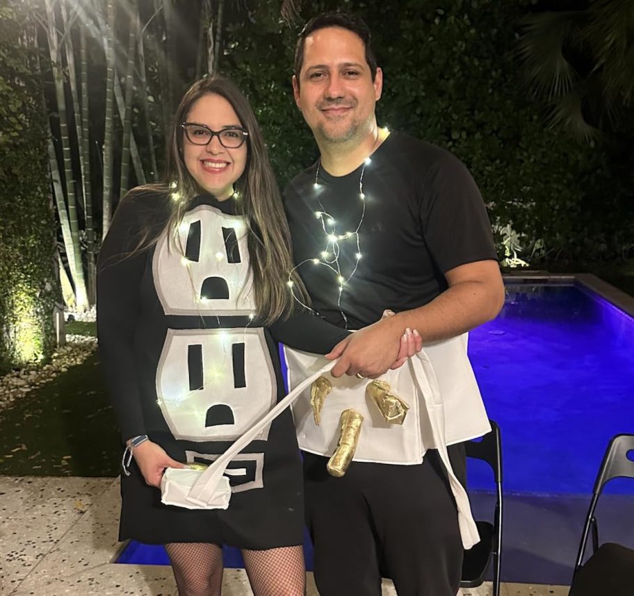 couple wearing plug and socket costume outside in dark