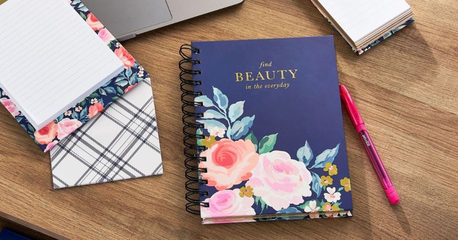 stationary on desk in front of laptop