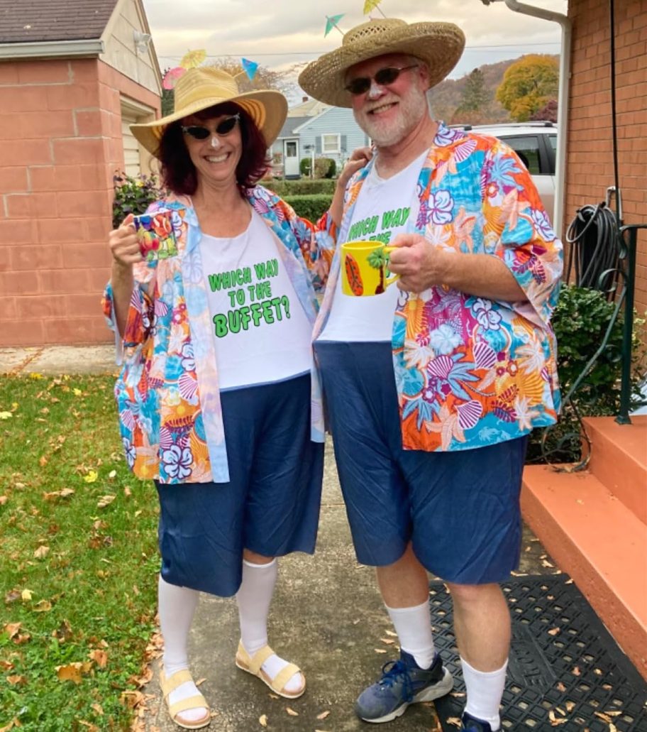 two people dressed up in tacky traveler costumes outside